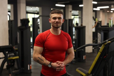 Photo of Portrait of professional personal trainer in gym