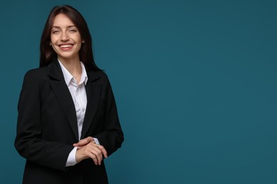 Photo of Happy woman in suit on light blue background, space for text