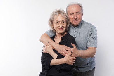 Photo of Portrait of lovely senior couple on white background, space for text