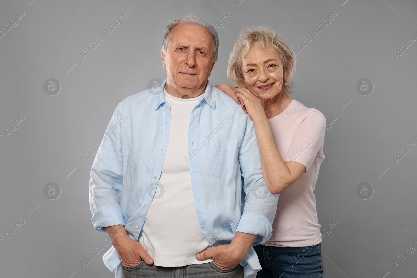 Portrait of lovely senior couple on grey background Photo of Portrait of lovely senior couple on grey background