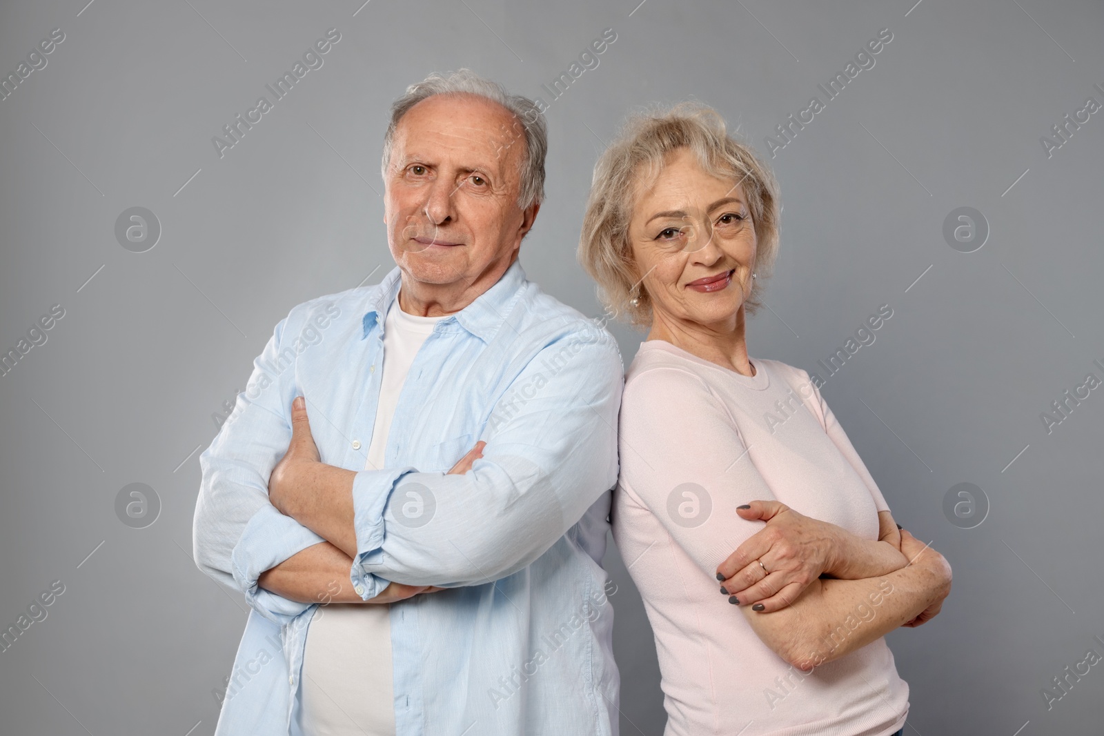 Portrait of lovely senior couple on grey background Photo of Portrait of lovely senior couple on grey background