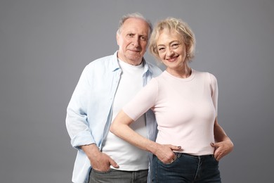 Photo of Portrait of lovely senior couple on grey background