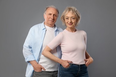 Photo of Portrait of lovely senior couple on grey background