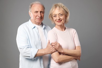 Photo of Portrait of lovely senior couple on grey background