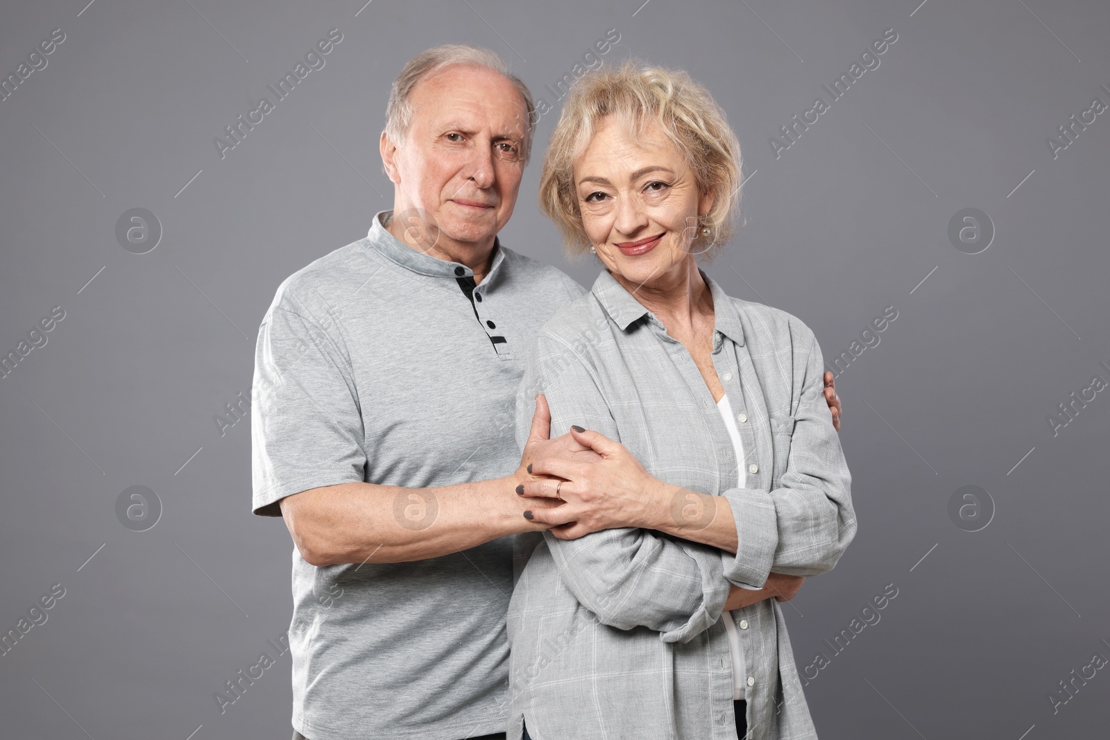 Portrait of lovely senior couple on grey background Photo of Portrait of lovely senior couple on grey background