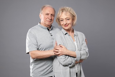 Photo of Portrait of lovely senior couple on grey background