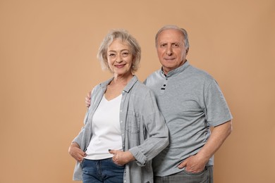 Photo of Portrait of lovely senior couple on beige background