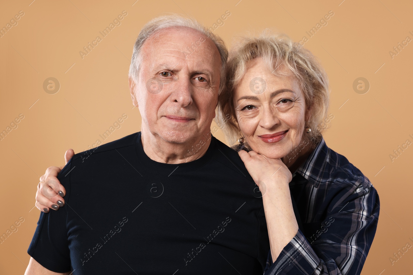 Portrait of lovely senior couple on beige background Photo of Portrait of lovely senior couple on beige background