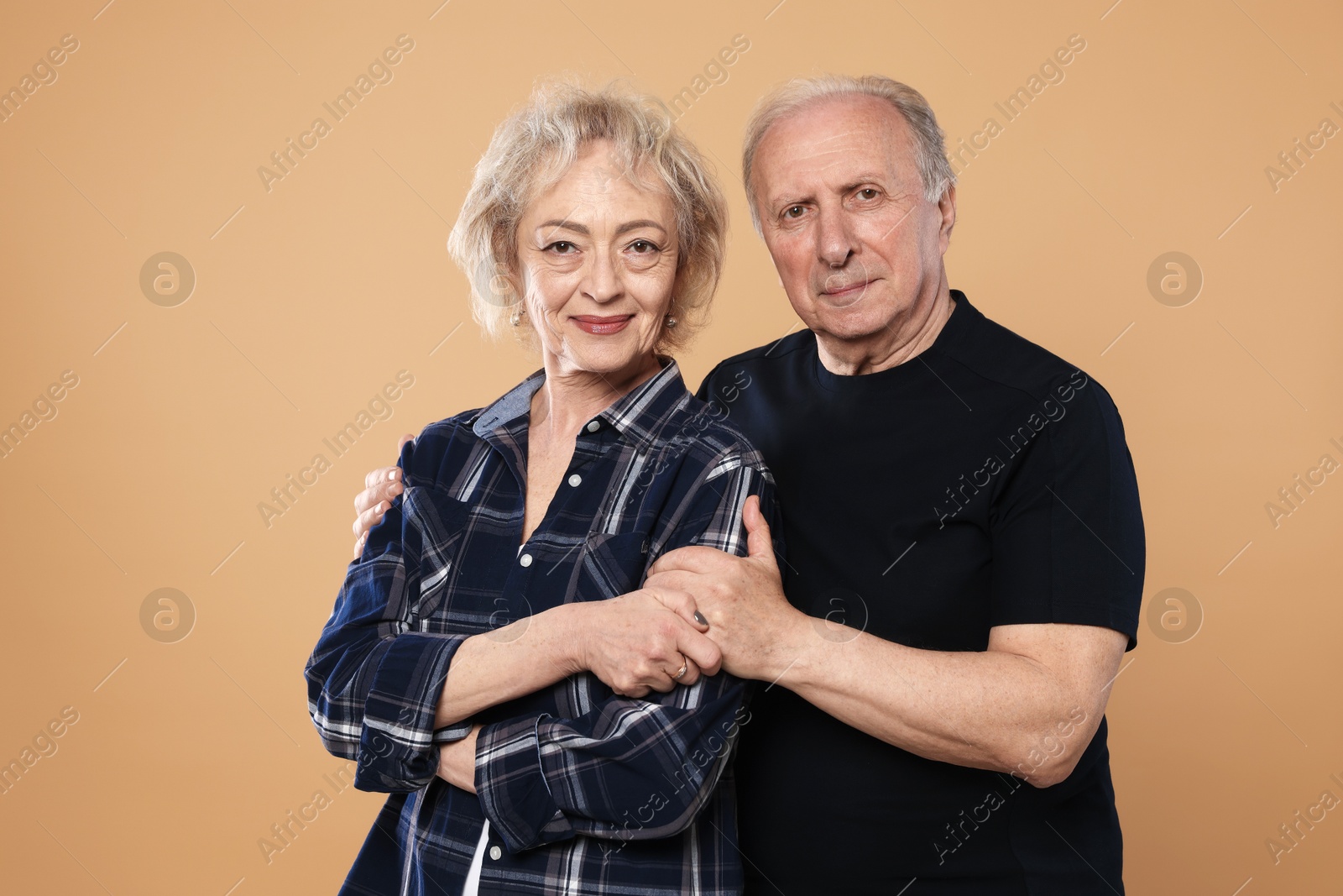 Portrait of lovely senior couple on beige background Photo of Portrait of lovely senior couple on beige background