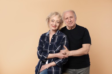 Photo of Portrait of lovely senior couple on beige background