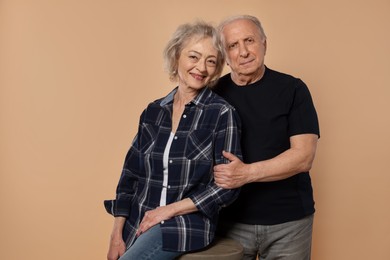 Photo of Portrait of lovely senior couple on beige background