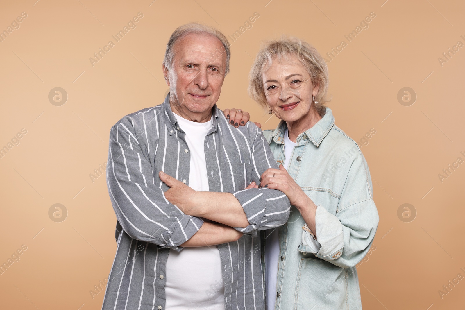 Portrait of lovely senior couple on beige background Photo of Portrait of lovely senior couple on beige background