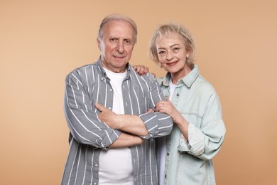 Photo of Portrait of lovely senior couple on beige background