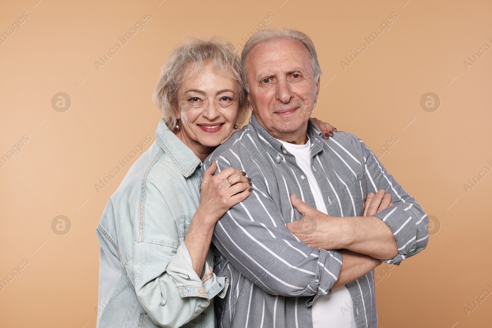 Portrait of lovely senior couple on beige background Photo of Portrait of lovely senior couple on beige background
