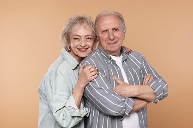 Photo of Portrait of lovely senior couple on beige background