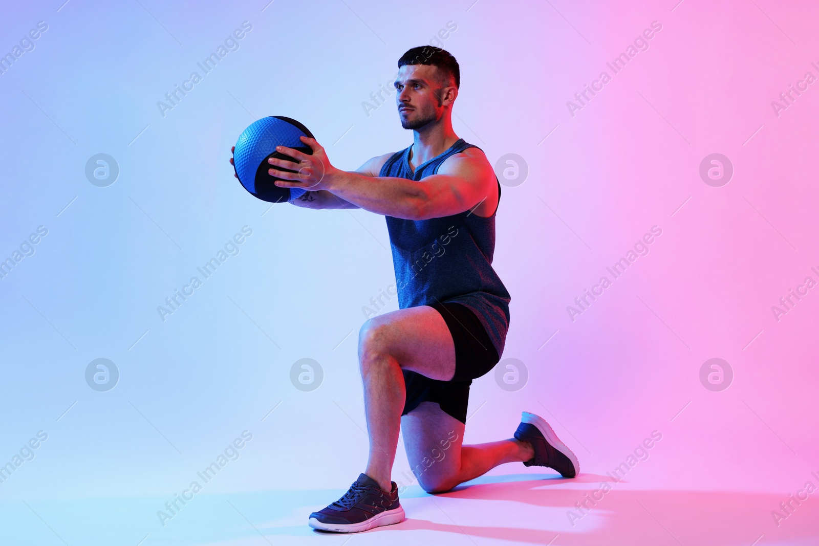 Man exercising with medicine ball on color background Photo of Man exercising with medicine ball on color background