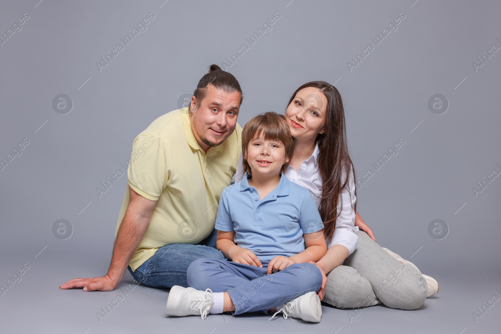 Portrait of happy family on grey background Photo of Portrait of happy family on grey background
