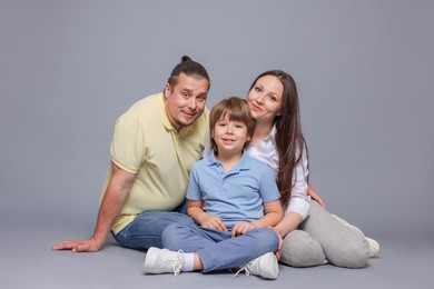 Photo of Portrait of happy family on grey background