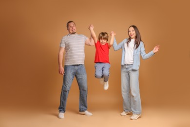 Photo of Portrait of happy family on brown background