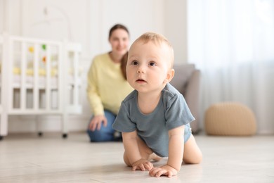 Photo of Mother and her little baby at home, selective focus