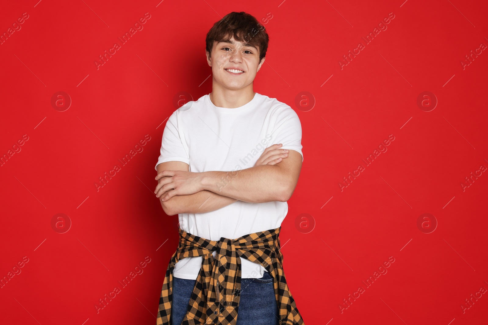 Photo of Portrait of teenage boy on red background