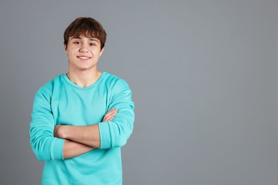Photo of Portrait of teenage boy on grey background. Space for text