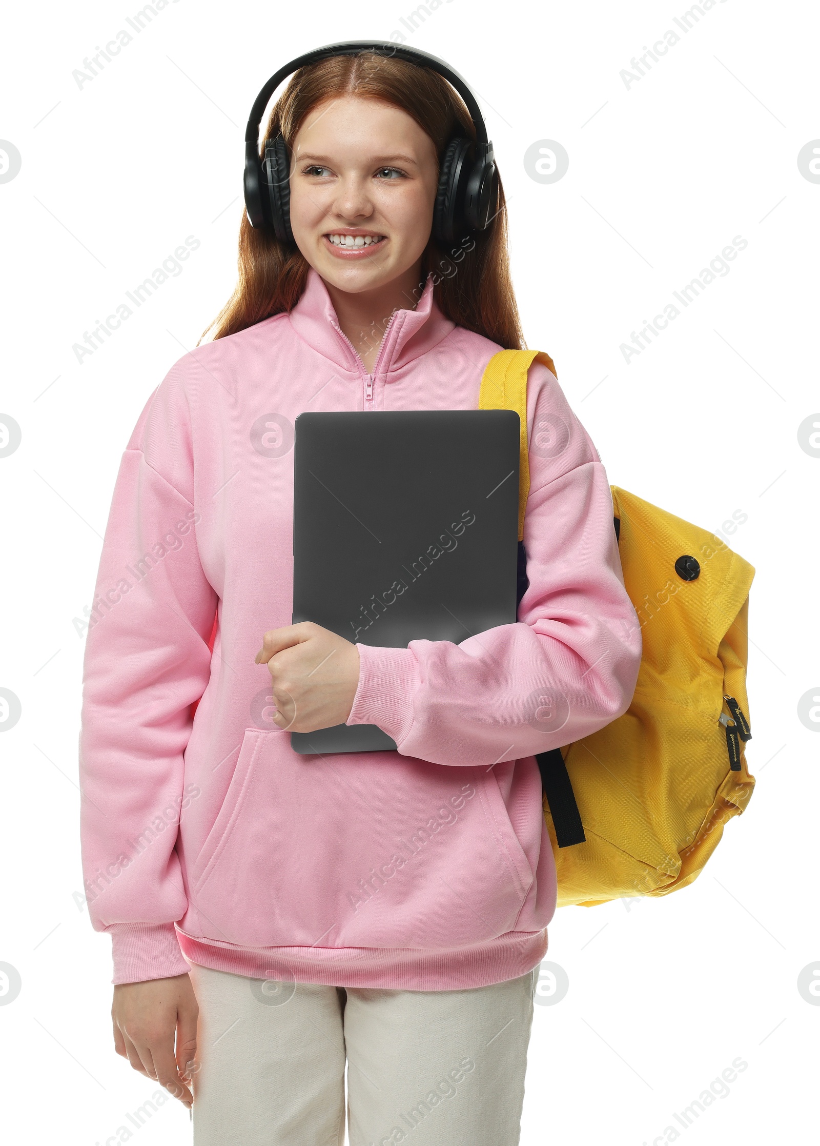 Teenage girl with laptop, headphones and backpack on white background Photo of Teenage girl with laptop, headphones and backpack on white background