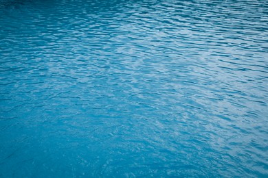 Photo of Clear water with ripples in outdoor swimming pool, closeup