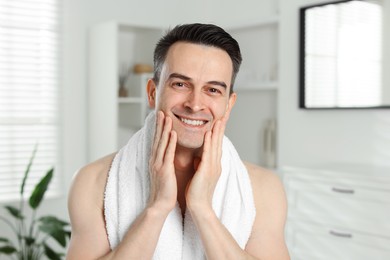 Photo of Portrait of smiling man after shaving at home