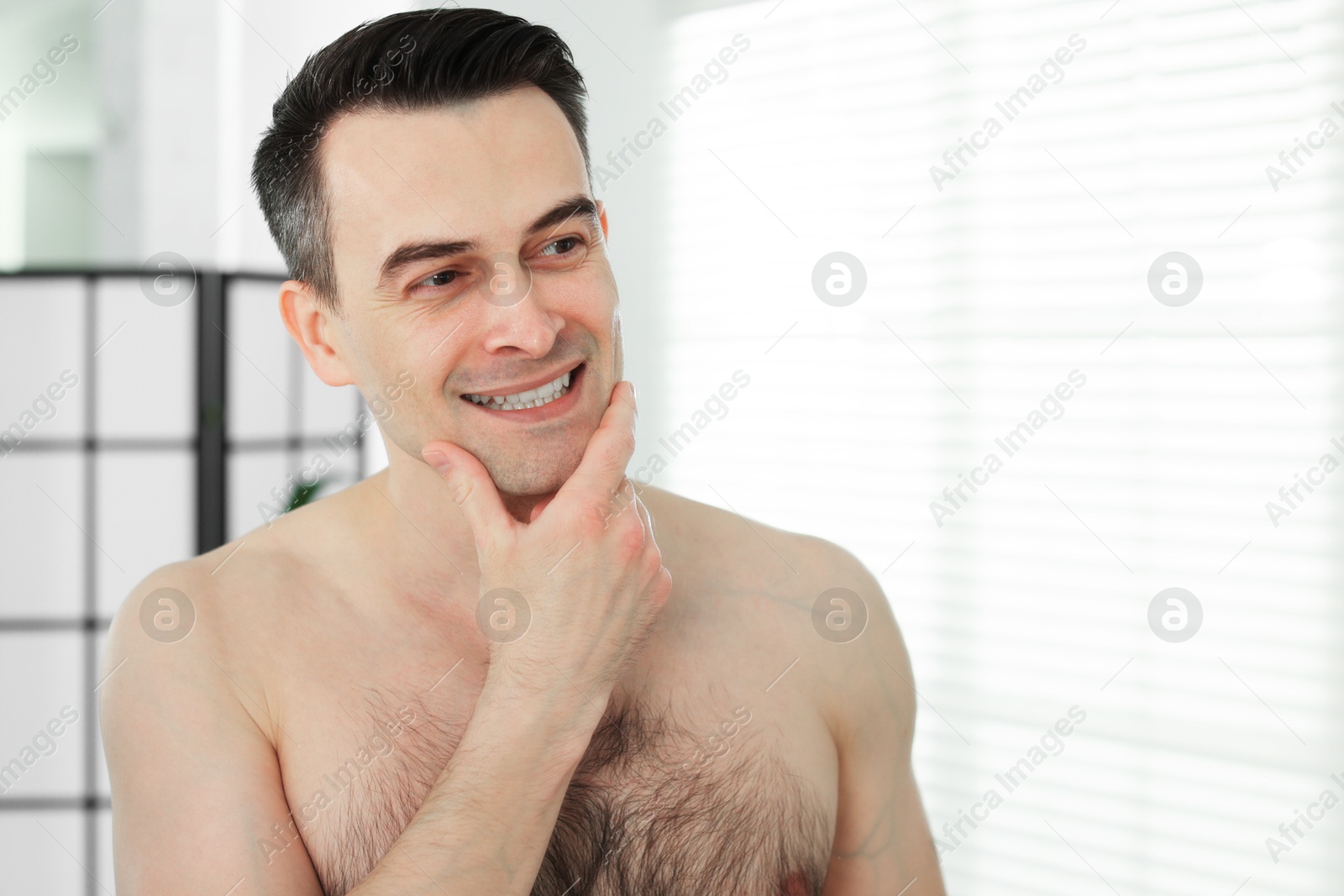 Portrait of smiling man after shaving at home Photo of Portrait of smiling man after shaving at home