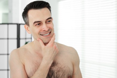 Photo of Portrait of smiling man after shaving at home