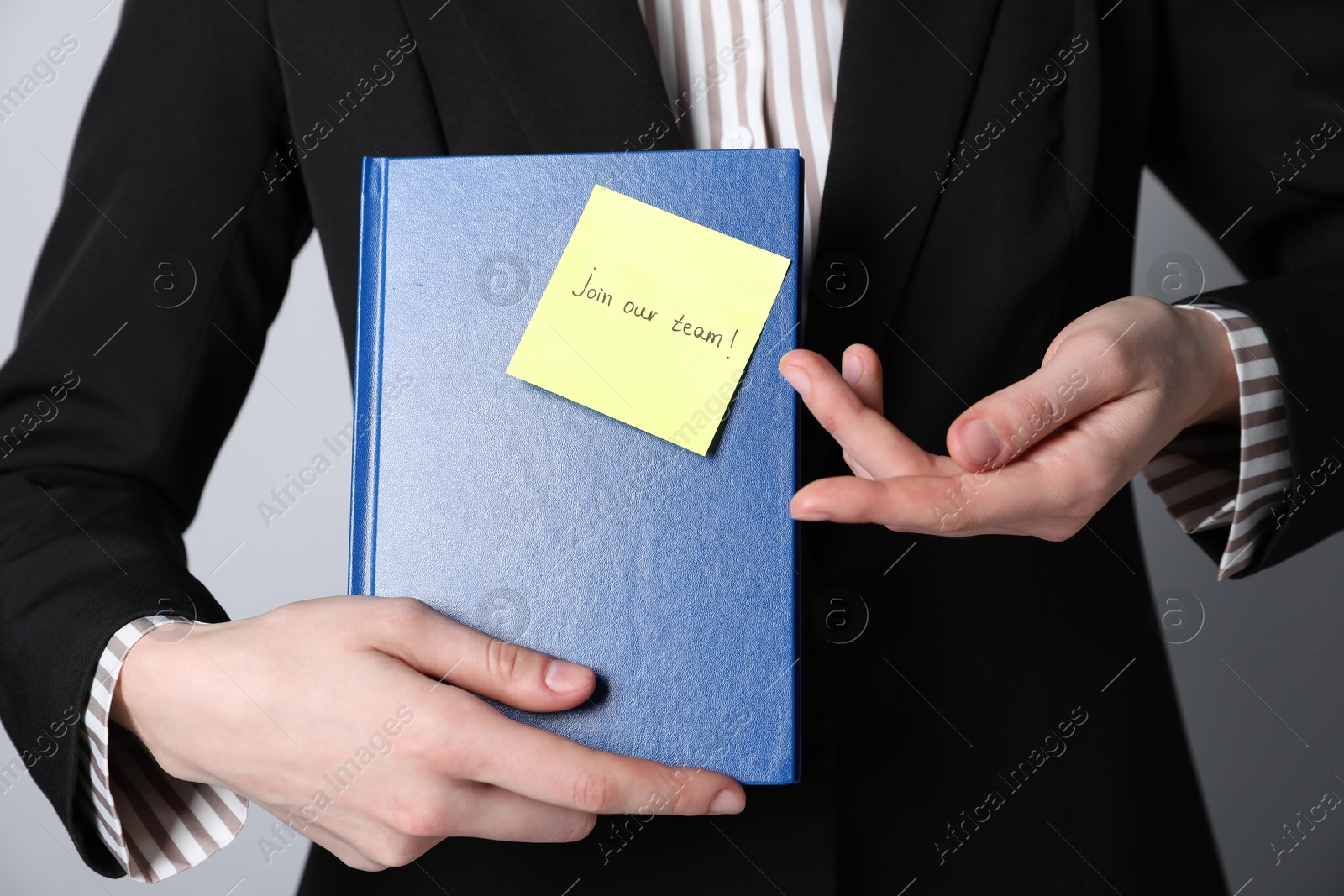 Join Our Team. Human resources manager holding notepad with sticky note on grey background, closeup Photo of Join Our Team. Human resources manager holding notepad with sticky note on grey background, closeup