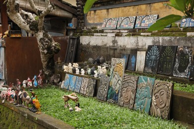 Photo of Bali, Indonesia - May 31, 2025: Different paintings and figures at market