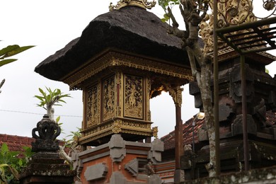 Photo of Bali, Indonesia - May 31, 2025: Beautiful temple with golden carvings
