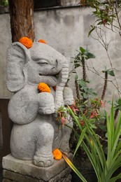 Photo of Bali, Indonesia - May 31, 2025: Beautiful Ganesha statue with flowers at temple