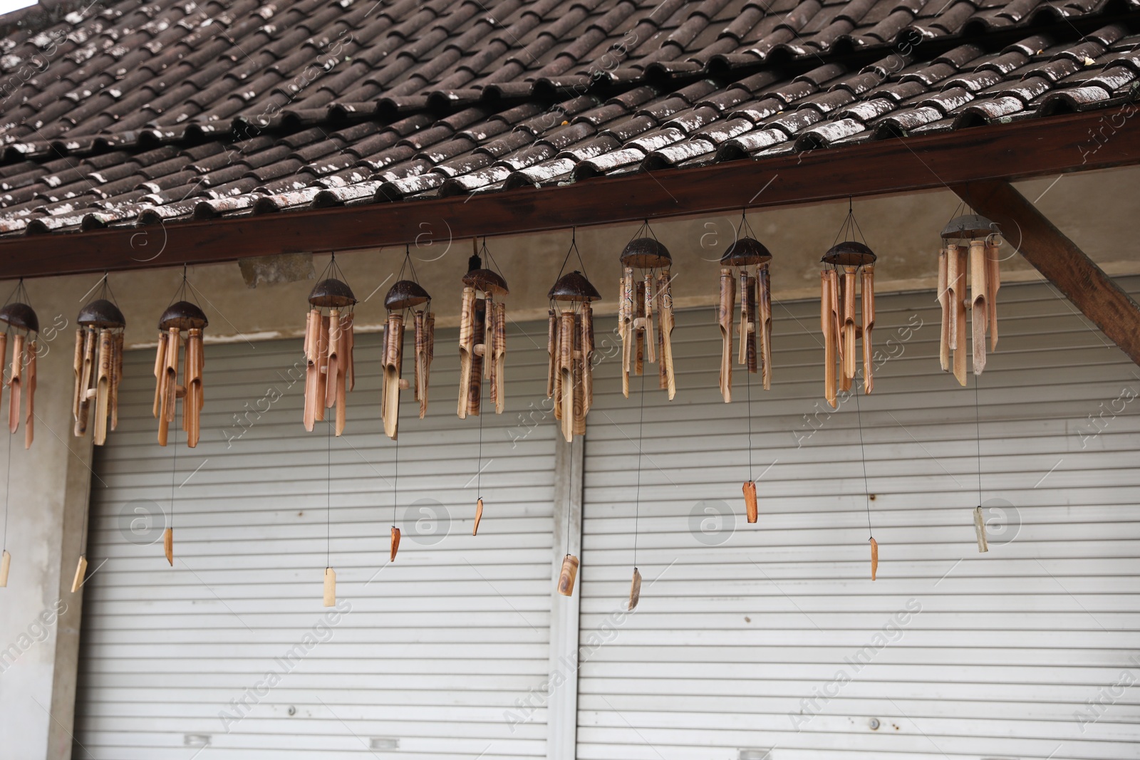 Many wooden wind chimes hanging in market Photo of Many wooden wind chimes hanging in market