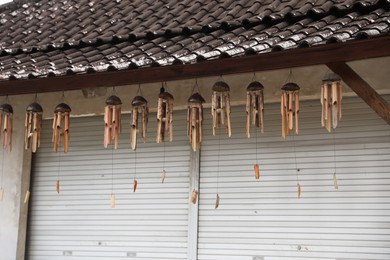 Photo of Many wooden wind chimes hanging in market
