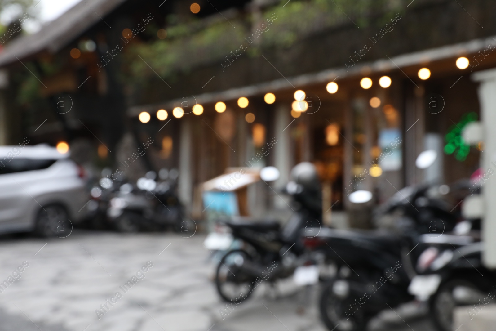 Blurred view of scooters parked near shop Photo of Blurred view of scooters parked near shop