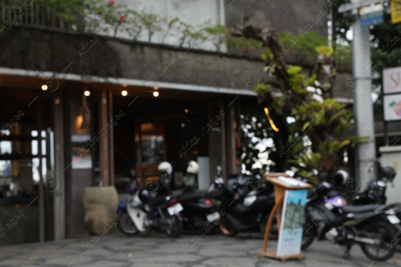 Blurred view of scooters parked near shop Photo of Blurred view of scooters parked near shop