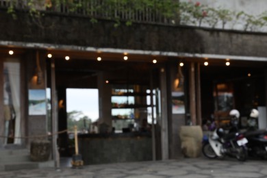 Photo of Blurred view of scooters parked near shop