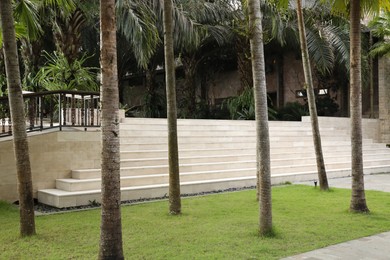 Photo of Bali, Indonesia - June 04, 2025: Different tropical plants, building and stairs outdoors