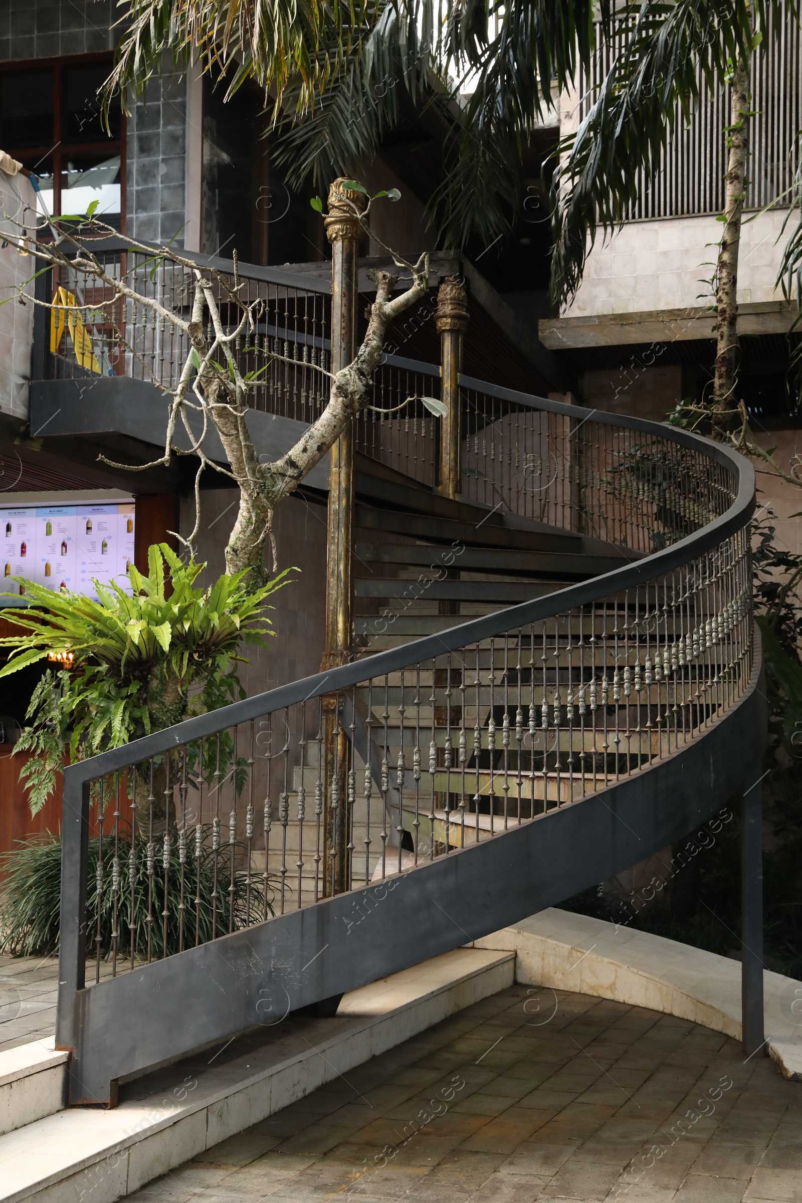 Bali, Indonesia - June 04, 2025: Metal stairs with railings and green plants outdoors Photo of Bali, Indonesia - June 04, 2025: Metal stairs with railings and green plants outdoors