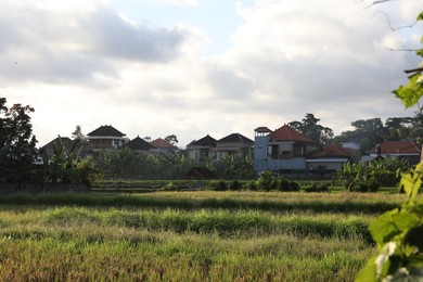 Photo of Beautiful view of field and buildings on sunny day