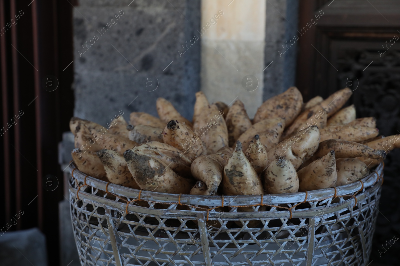 Basket with raw sweet potatoes in market, closeup Photo of Basket with raw sweet potatoes in market, closeup