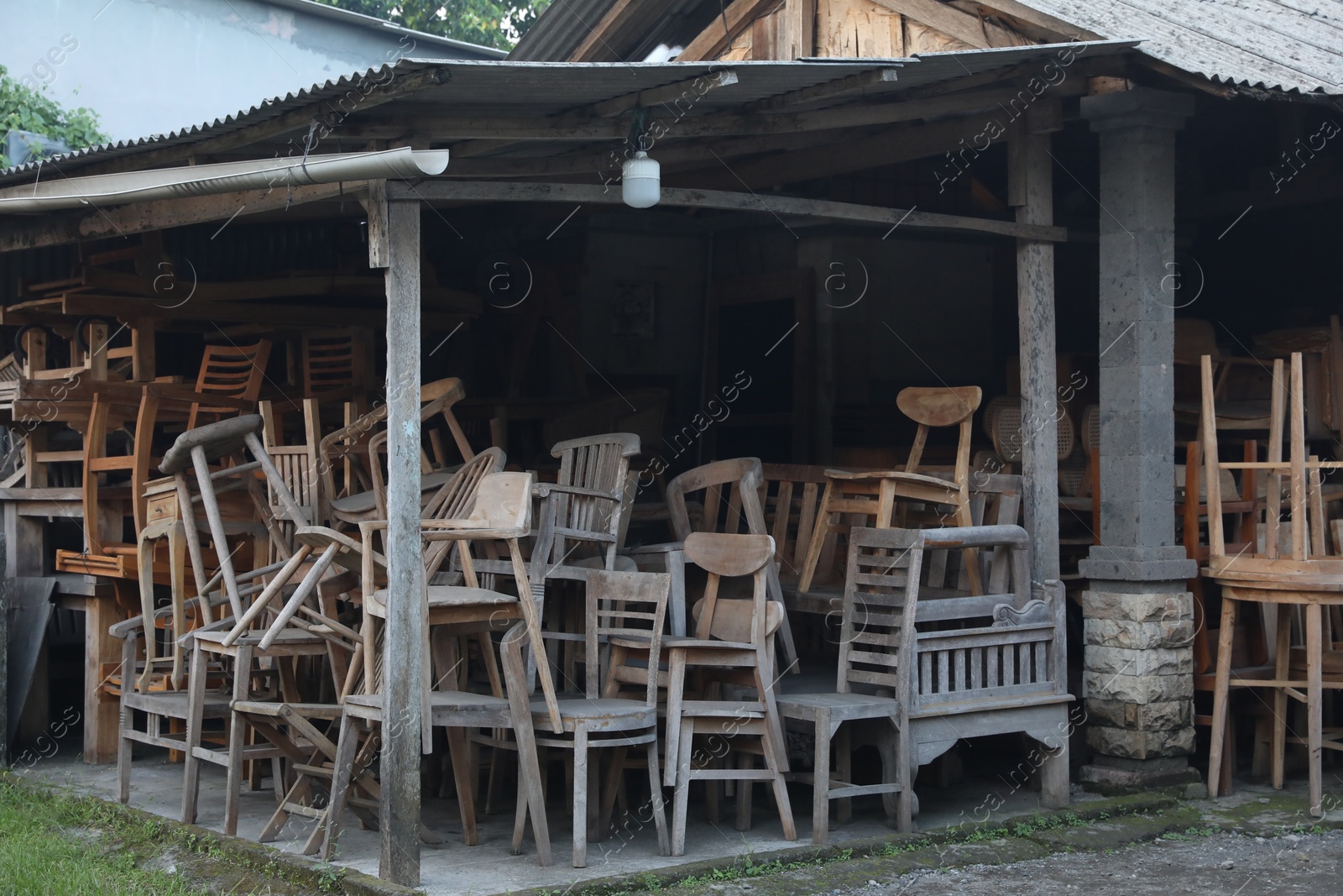 Many old wooden chairs and tables in storage Photo of Many old wooden chairs and tables in storage