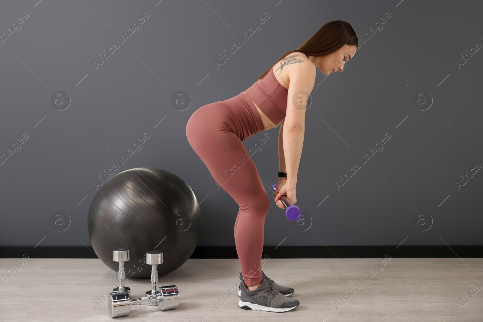 Woman exercising with body bar in fitness studio Photo of Woman exercising with body bar in fitness studio