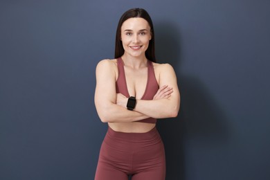 Photo of Woman in fitness clothes on grey background