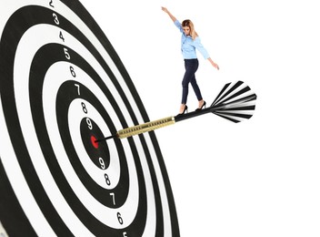 Image of Targeting, goal achievement. Art collage with businesswoman walking on dart sticking in center of dartboard against white background