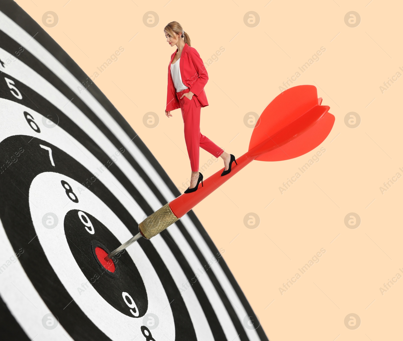 Goal achievement, business success and targeting. Businesswoman walking on dart sticking in center of dartboard against beige background Image of Goal achievement, business success and targeting. Businesswoman walking on dart sticking in center of dartboard against beige background