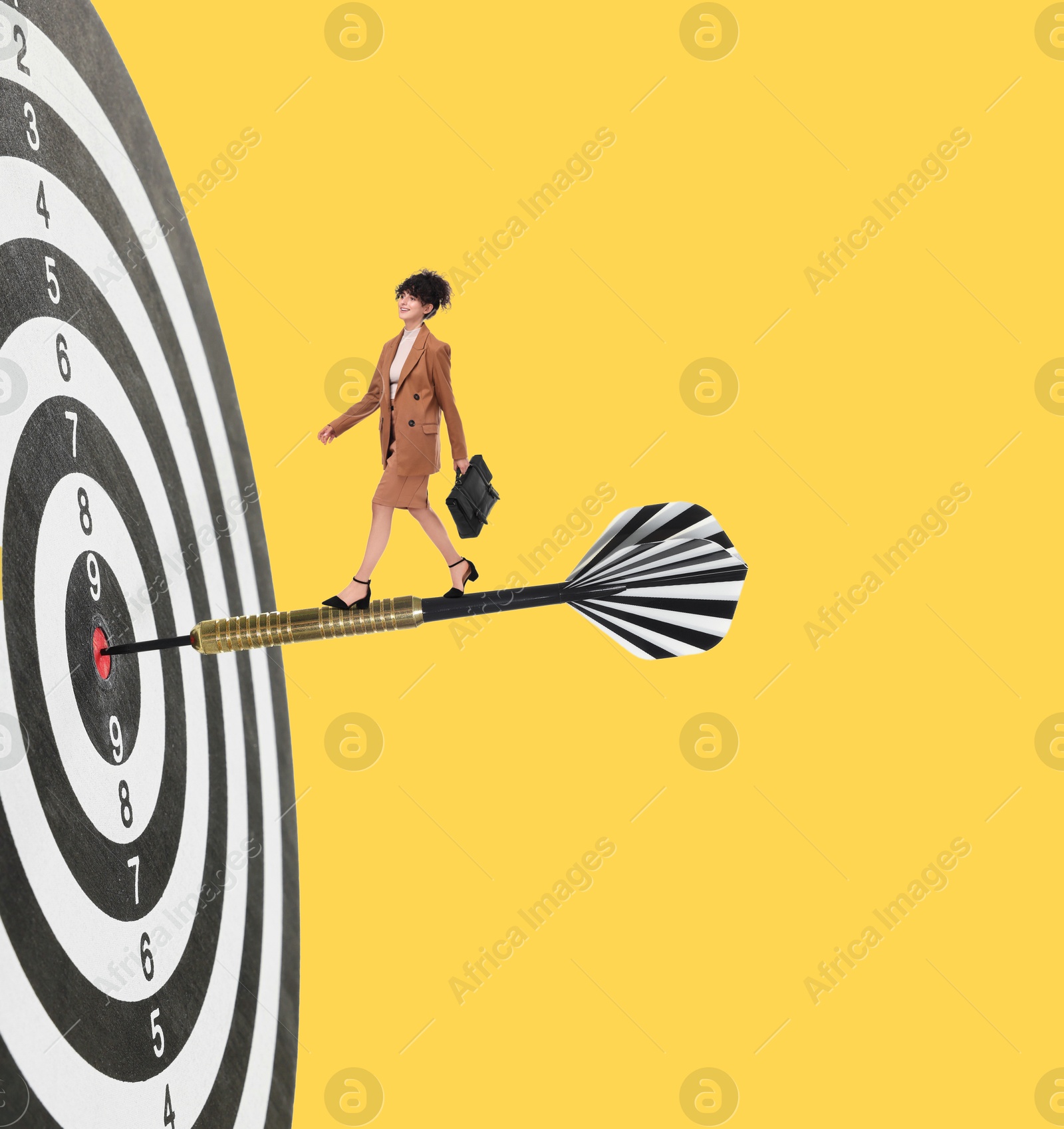Concepts of targeting, decision and goal achievement. Businesswoman walking on dart sticking in center of dartboard against yellow background Image of Concepts of targeting, decision and goal achievement. Businesswoman walking on dart sticking in center of dartboard against yellow background
